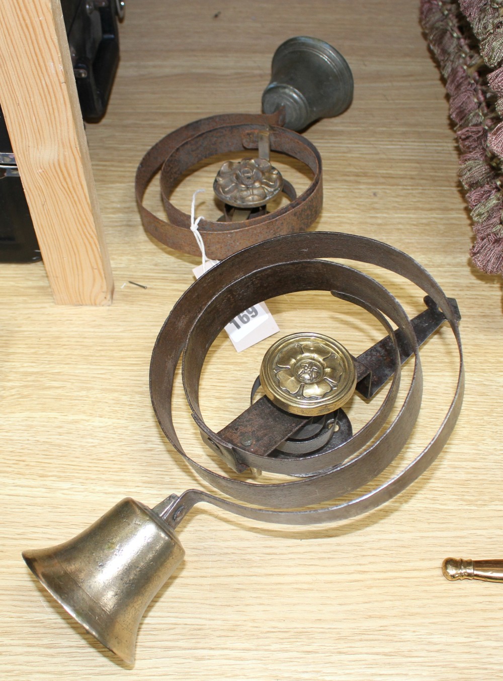 Two antique wrought iron and brass shop bells, height 33cm and 24cm